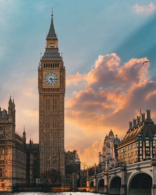 The image features a detailed view of the iconic Big Ben clock tower in London during sunset, with a partly cloudy sky illuminated by the warm glow of the setting sun. The historic tower, with its ornate Gothic Revival architecture, stands prominently over the River Thames, whose surface reflects the tower's structure. Adjacent historic buildings with decorative facades and chimneys line the riverbank, styled in traditional British architectural design. A single bird soars in the sky, adding a dynamic element to the scene. The scene captures the grandeur and historic charm of central London, with soft lighting highlighting the intricate stonework and glass windows of the surrounding structures. Cleaner Kingston upon Thames offers professional deep cleaning and sanitisation services for residential and commercial spaces, ensuring surfaces like polished wood, ceramic tiles, and glass are hygienic and spotless, suitable for end of tenancy cleaning. This image exemplifies the importance of maintaining cleanliness and presentation in historic and high-traffic areas, aligning with the company's expertise in surface cleaning and hygiene maintenance in Kingston upon Thames.