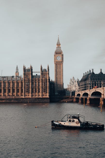The image features a detailed view of the iconic Big Ben clock tower in London during sunset, with a partly cloudy sky illuminated by the warm glow of the setting sun. The historic tower, with its ornate Gothic Revival architecture, stands prominently over the River Thames, whose surface reflects the tower's structure. Adjacent historic buildings with decorative facades and chimneys line the riverbank, styled in traditional British architectural design. A single bird soars in the sky, adding a dynamic element to the scene. The scene captures the grandeur and historic charm of central London, with soft lighting highlighting the intricate stonework and glass windows of the surrounding structures. Cleaner Kingston upon Thames offers professional deep cleaning and sanitisation services for residential and commercial spaces, ensuring surfaces like polished wood, ceramic tiles, and glass are hygienic and spotless, suitable for end of tenancy cleaning. This image exemplifies the importance of maintaining cleanliness and presentation in historic and high-traffic areas, aligning with the company's expertise in surface cleaning and hygiene maintenance in Kingston upon Thames.